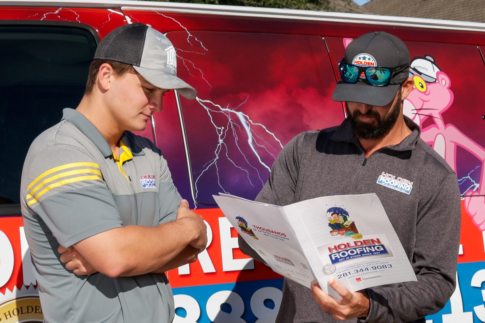 Holden project managers reviewing an inspection folder at the van