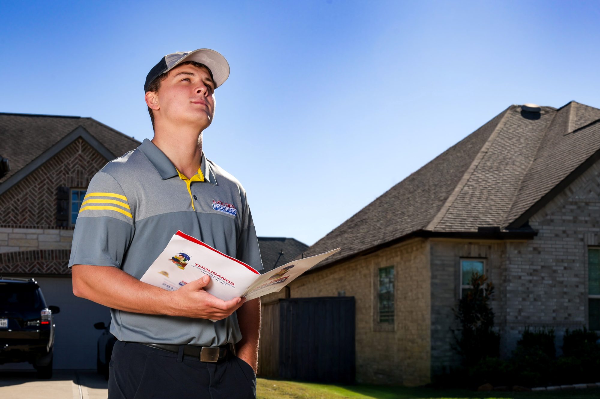 A Holden project manager with the inspection report outside a Texas home