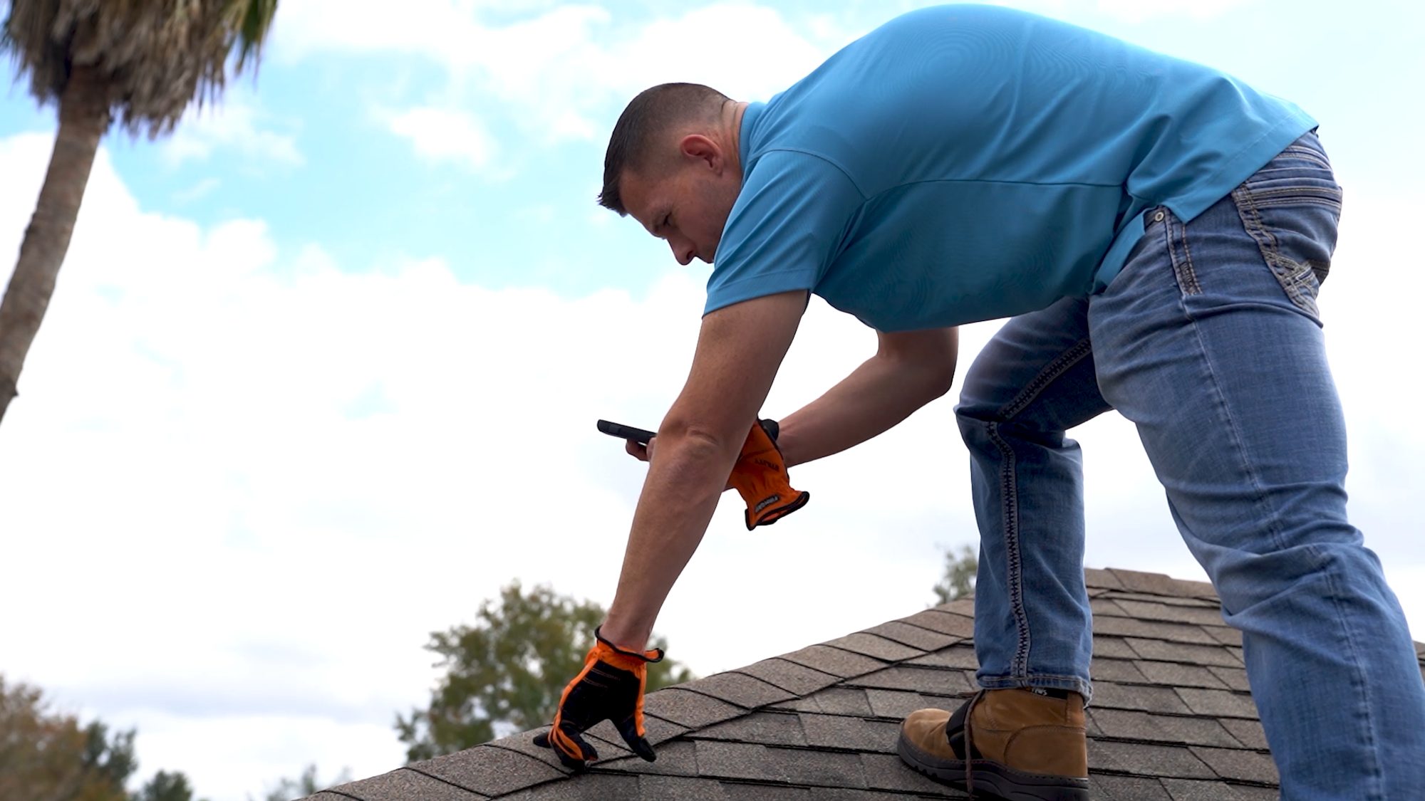 A roofer fastening shingles on a Texas roof