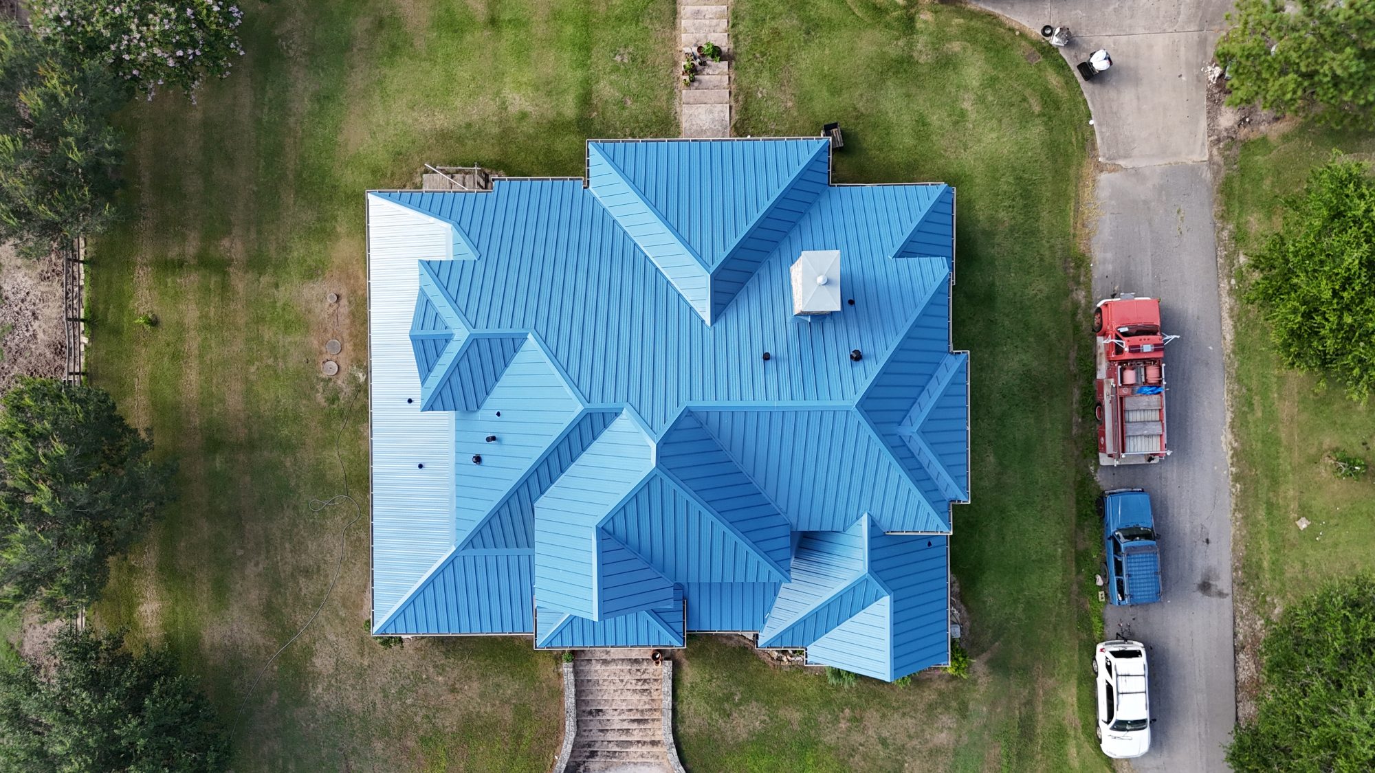 roofing contractor Kyle TX, Holden Roofing Austin standing seam metal roof replacement on a Blanco River Ranch acreage home, metal roofing and shingle roof replacement serving Kyle, Buda, Dripping Springs and Del Valle