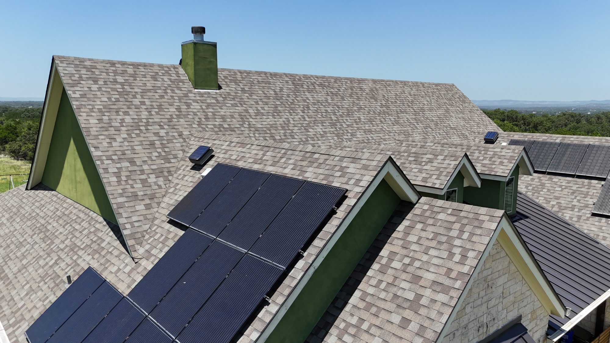 Architectural shingle roof with solar panels, aerial