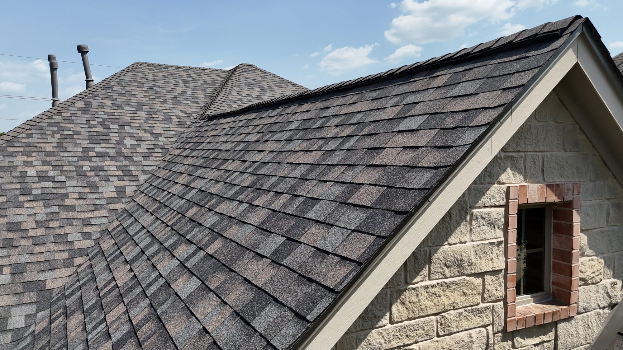 Brown architectural shingle close-up at the eave