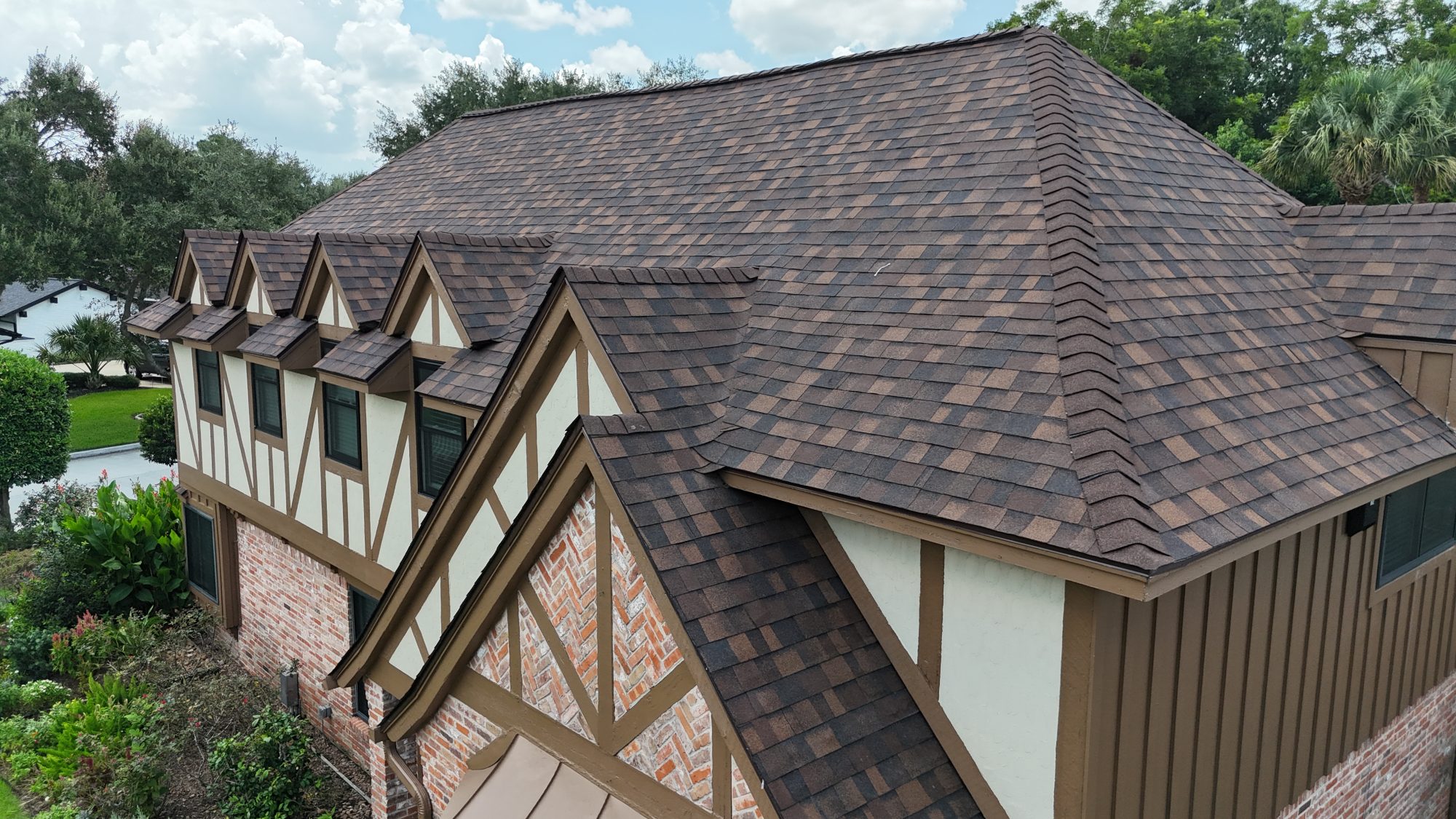 Brown shingle roof with dormers, aerial close