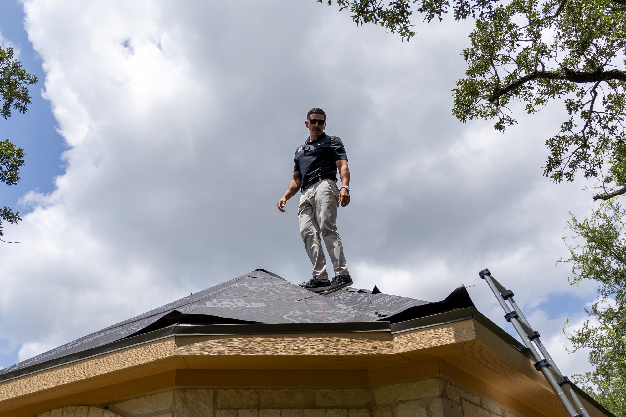 roof replacement Cedar Park TX, Holden Roofing Austin crew running a magnetic nail sweep after a one-day Owens Corning roof replacement in Anderson Mill West, roof replacement, roof repair and roof inspection serving Cedar Park, Round Rock, Leander and Lago Vista