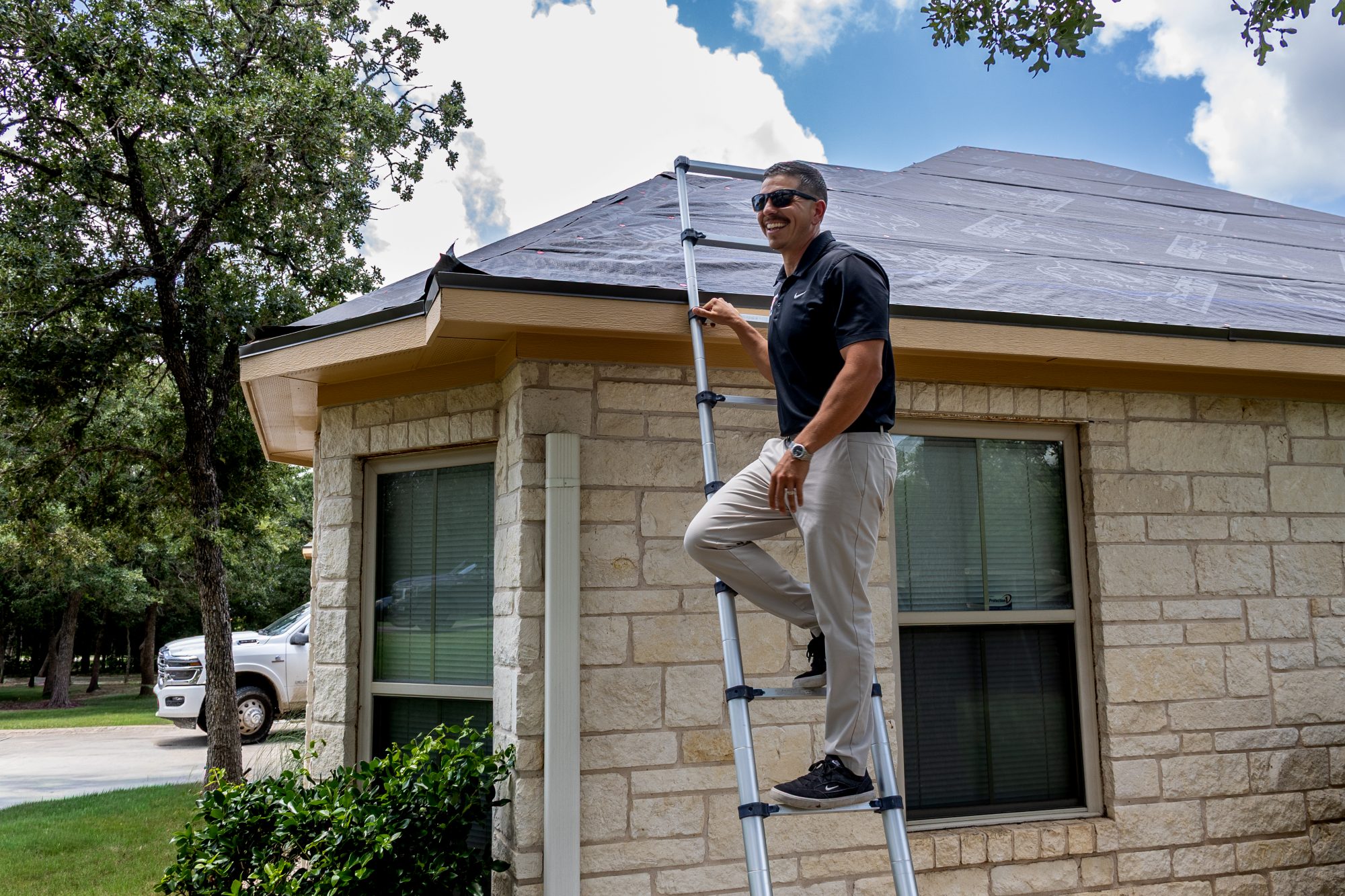 A Holden project manager climbing to a dried-in roof