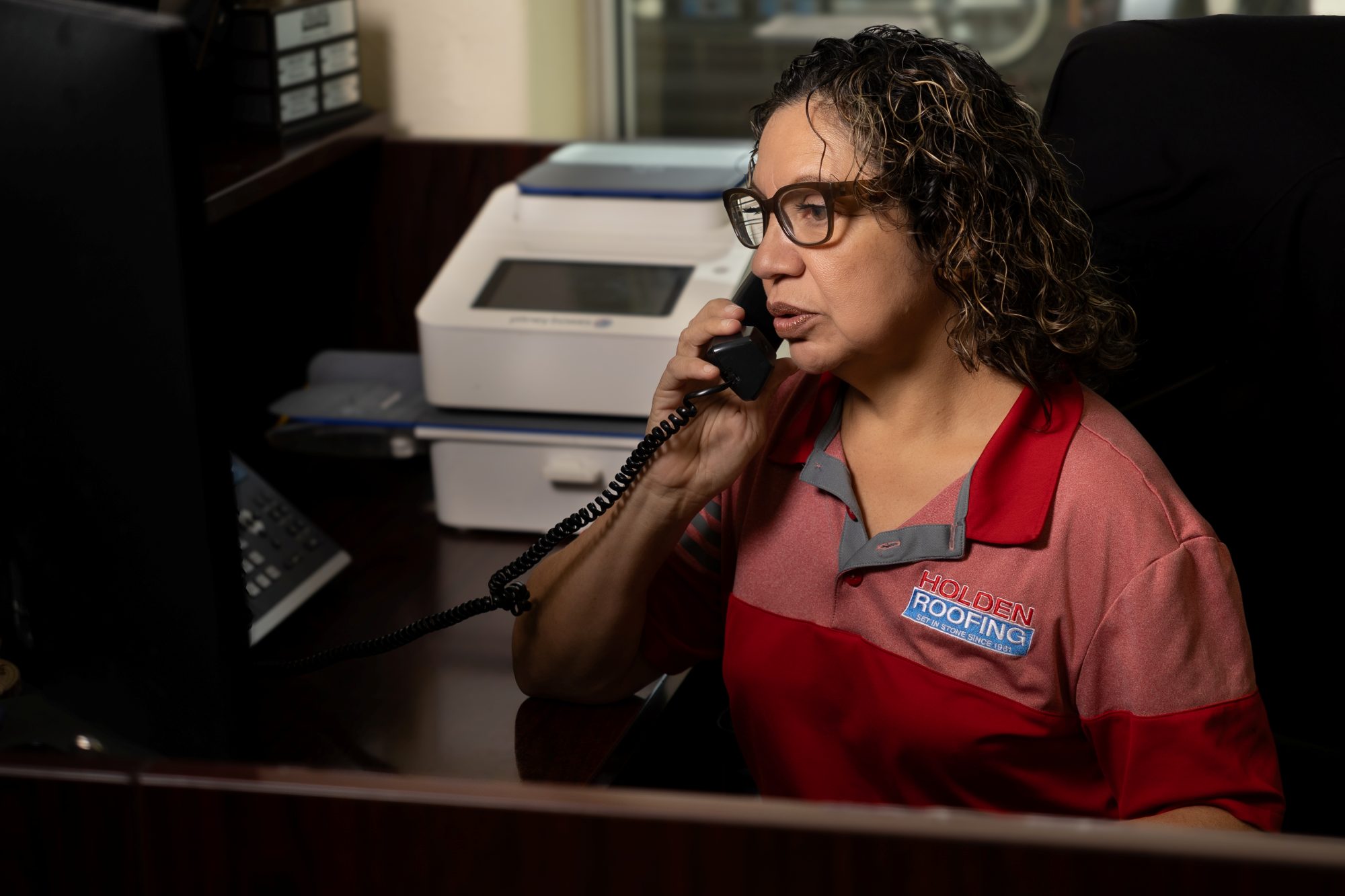 Holden Roofing office staff taking a call
