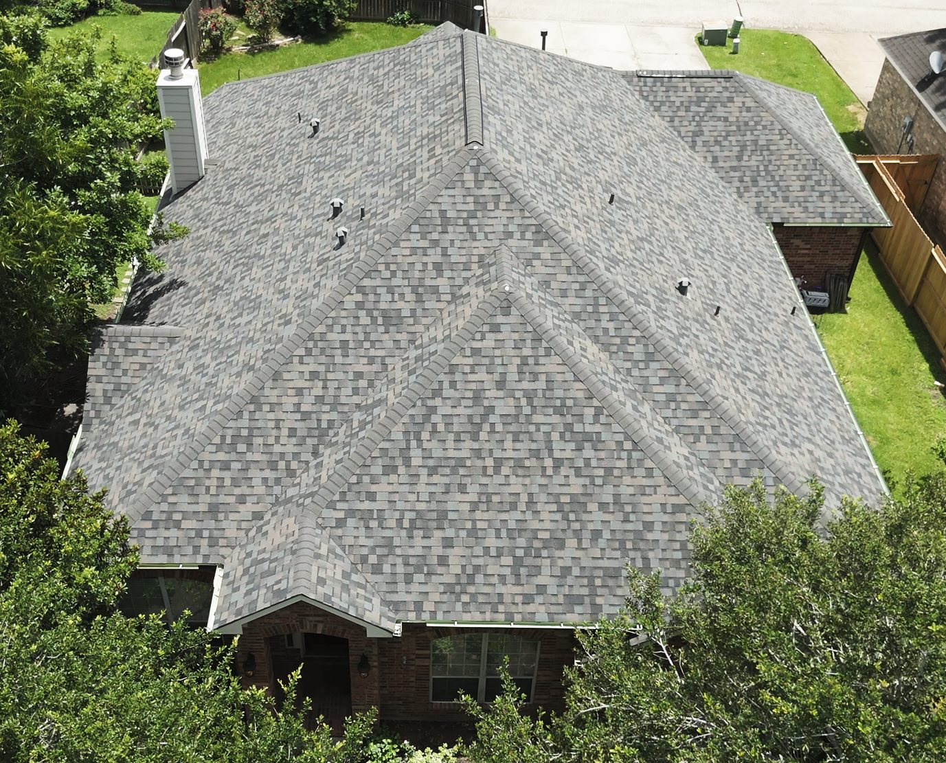 Architectural shingle roof on a brick home, aerial