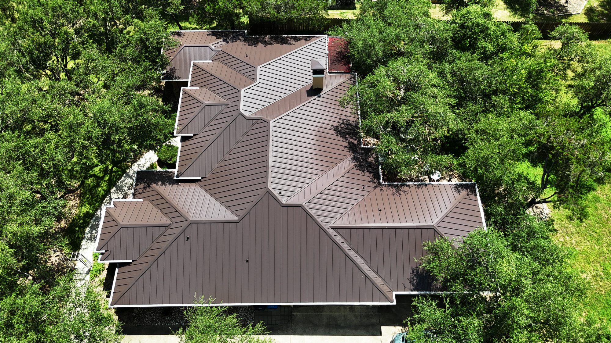 roofing contractor Austin TX, Holden Roofing Austin standing seam metal roof replacement on a Dripping Springs Hill Country home, metal roofing, tile roofing and shingle roof replacement serving Dripping Springs, Bee Cave, Lakeway and Westlake Hills