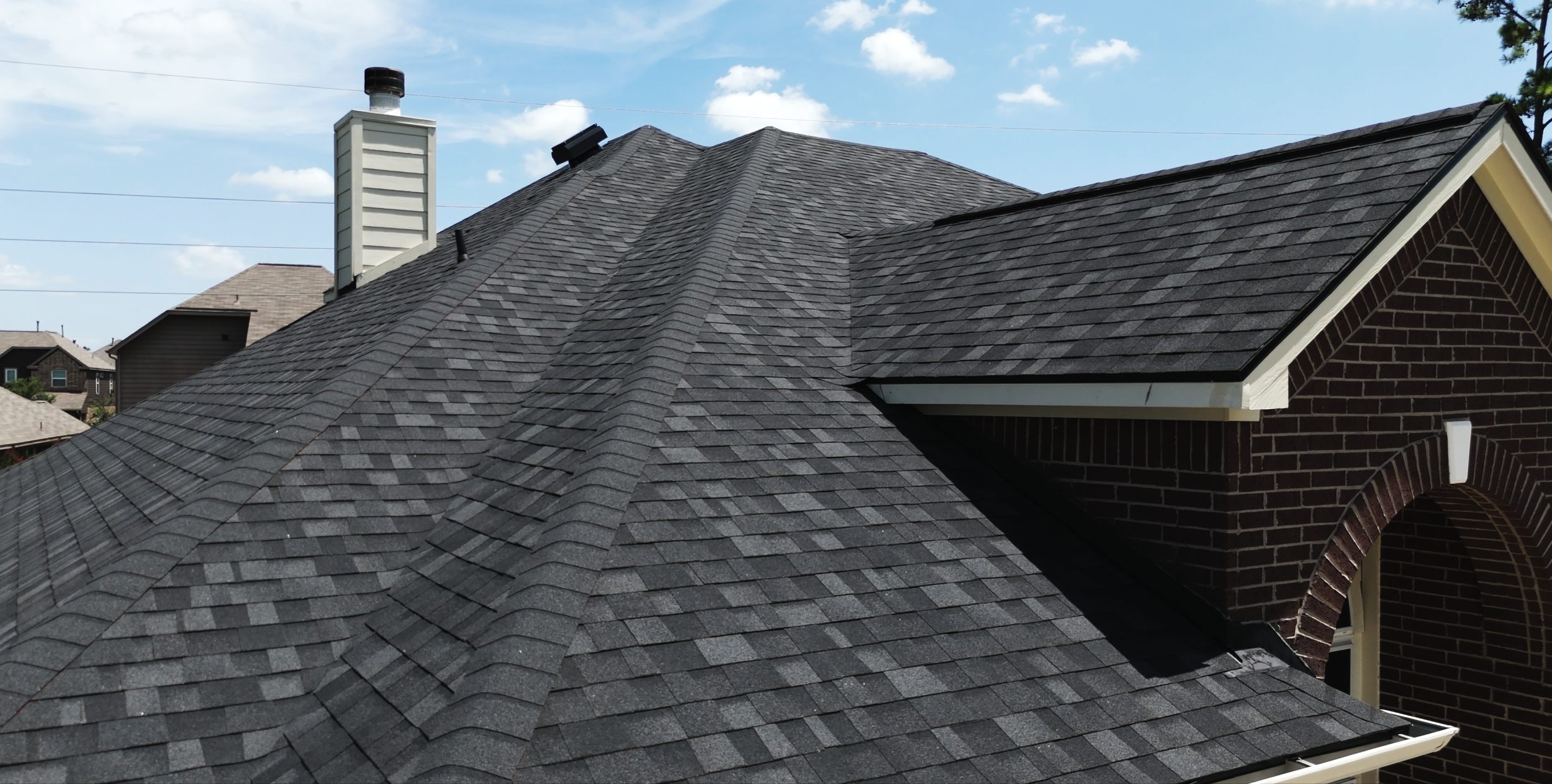 Black architectural shingle roof and chimney