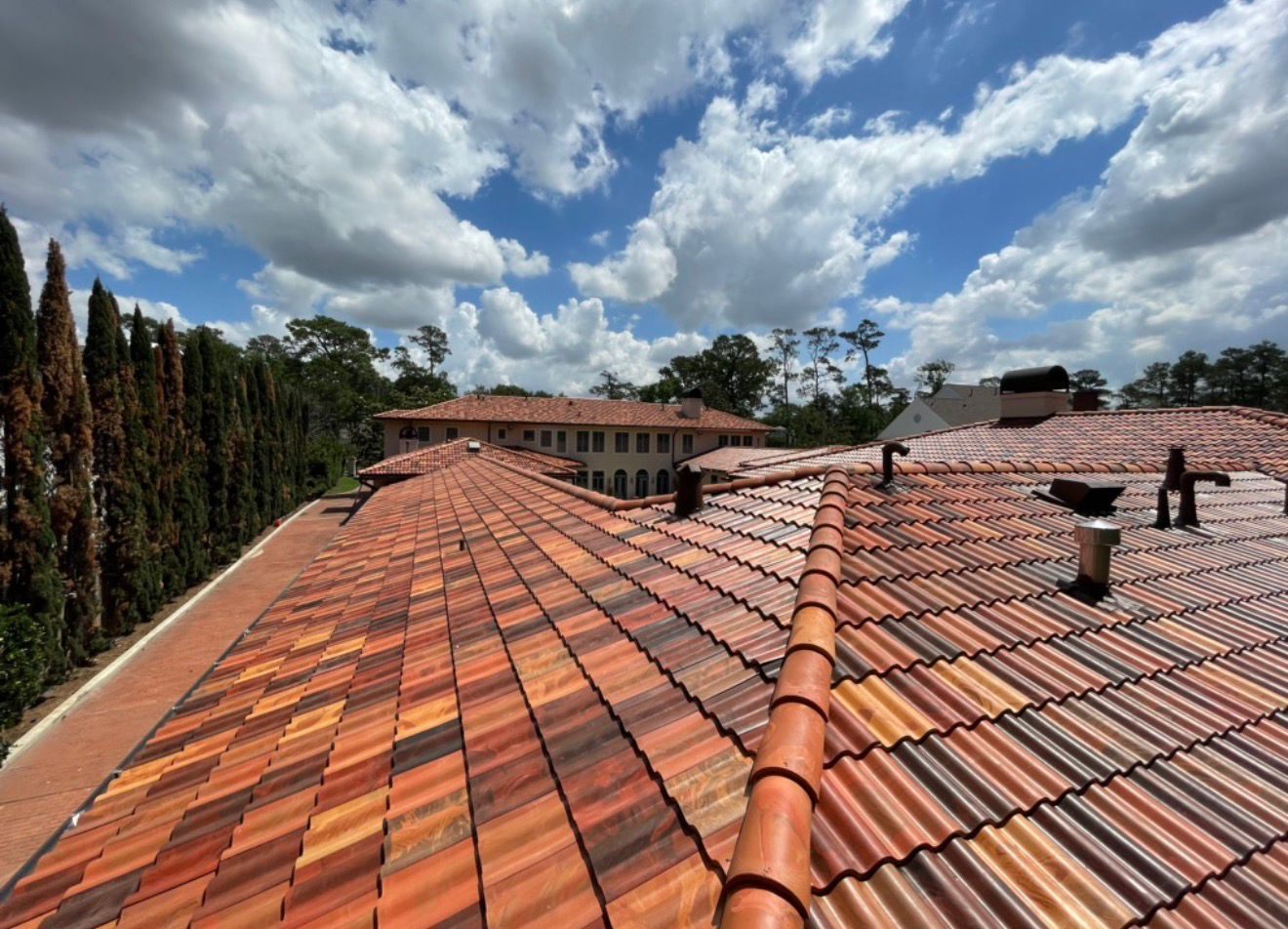 Terracotta tile roof under a Texas sky