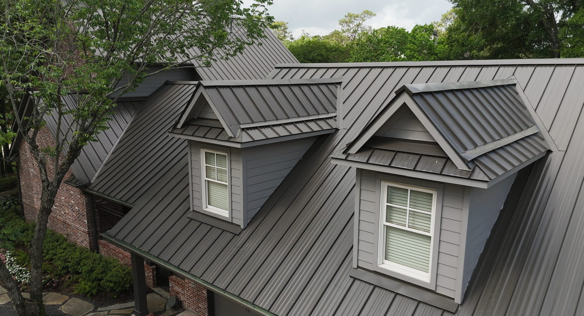 roofing contractor Rosenberg TX, Holden Roofing standing seam metal roof replacement on a Fort Bend County acreage home and barn, metal roofing, shingle roof replacement and tile roofing serving Rosenberg, Needville, Beasley and Simonton